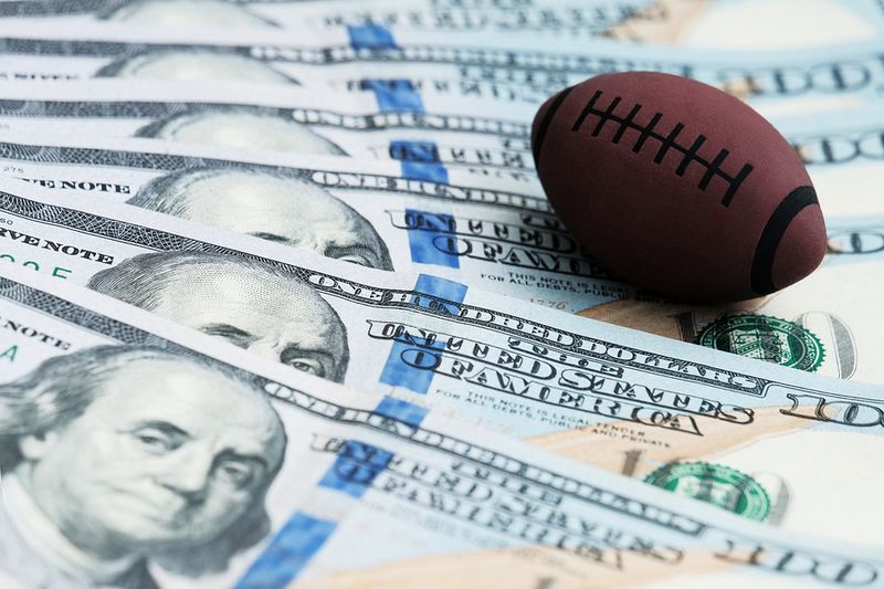 Dollars and US football ball