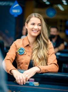 Winning poker player Sofia Lövgren smiling at the poker table.