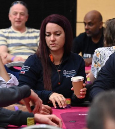 Female poker pro Katie Swift studying the ongoing poker game.