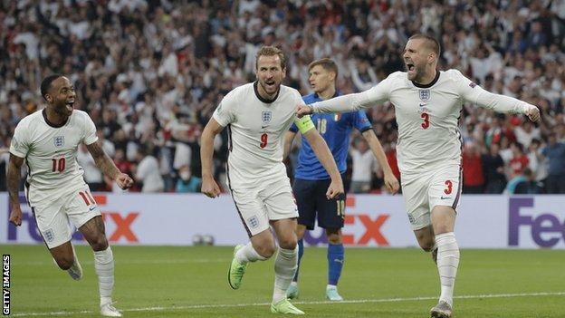 Football players cheering after scoring a goal.