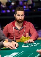Jonathan Duhamel throwing away his hand at the poker table.