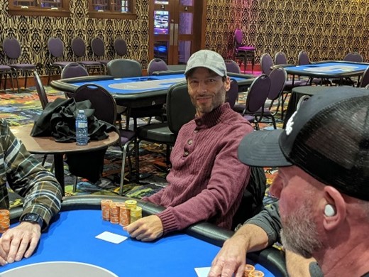 Paul Sokoloff smiling at a poker table sitting with a big stack.