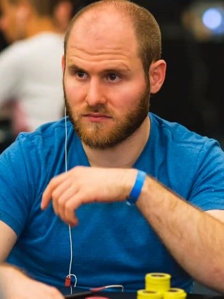Sam Greenwood staring while at a poker table.