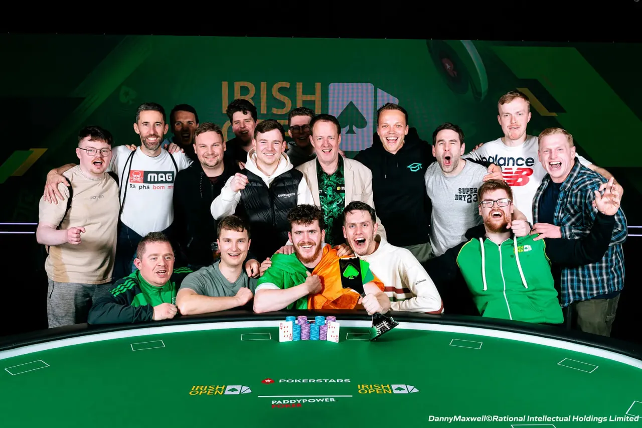 Irish Poker Open winners in front of poker table.