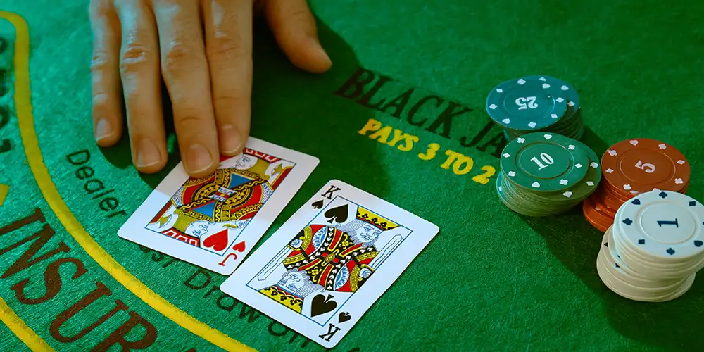 Dealer Holding Cards at Blackjack Table