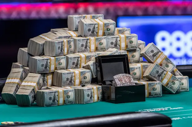 Pile of cash and WSOP bracelet