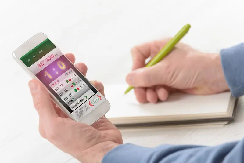 Betting on a phone and taking notes