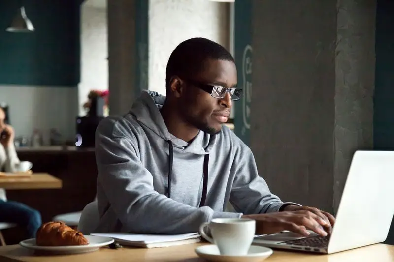 Young man studying on his laptop.