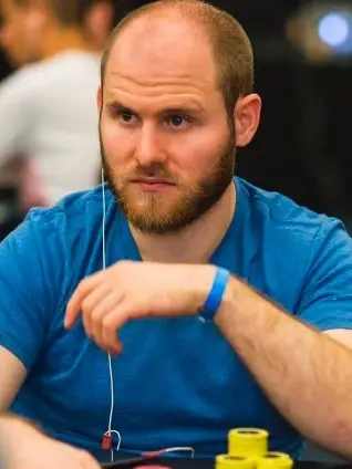 Sam Greenwood staring while at a poker table.