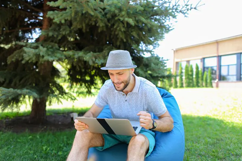 Man winning playing and winning online in his garden