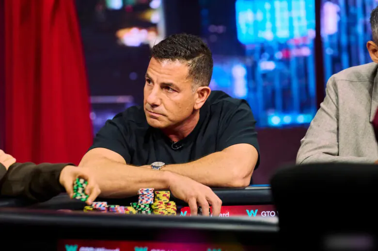 A close-up of Brandon Steven’s hand placing poker chips in front of him during a high-stakes World Poker Tour event.
